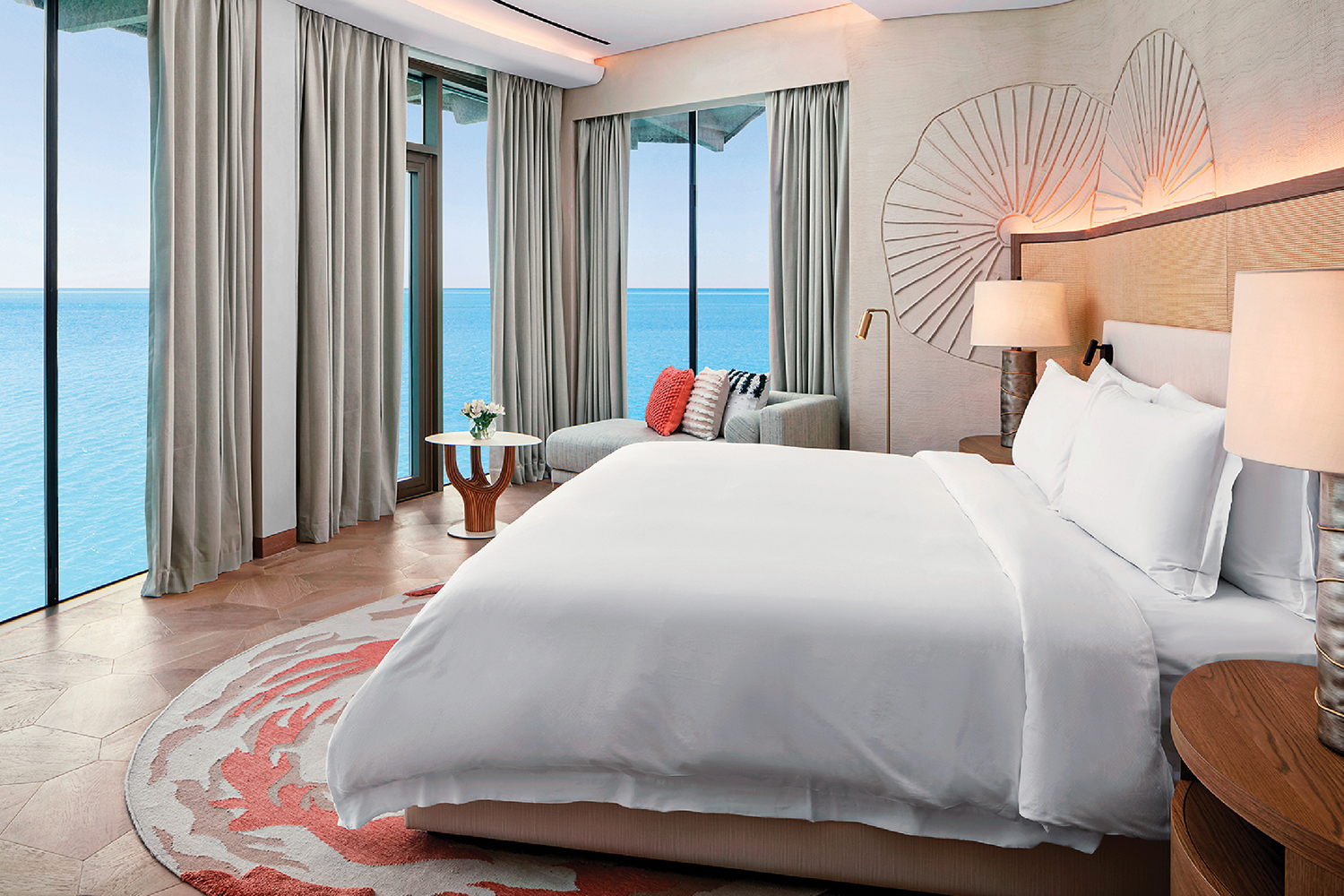 A bedroom with a large bed and a view of the ocean