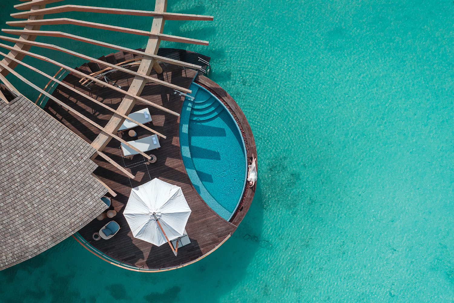 A boat is floating in the water with umbrellas