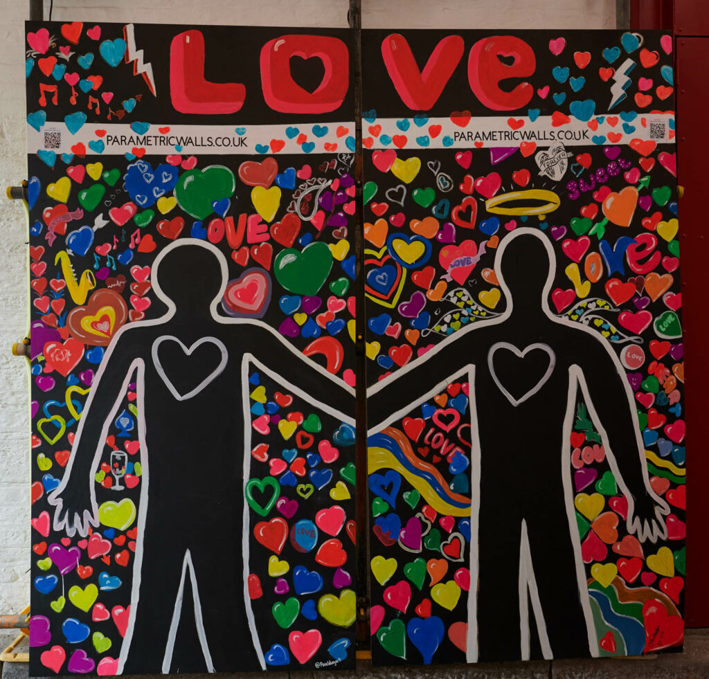 a wall mural with the shape of two people and the words love