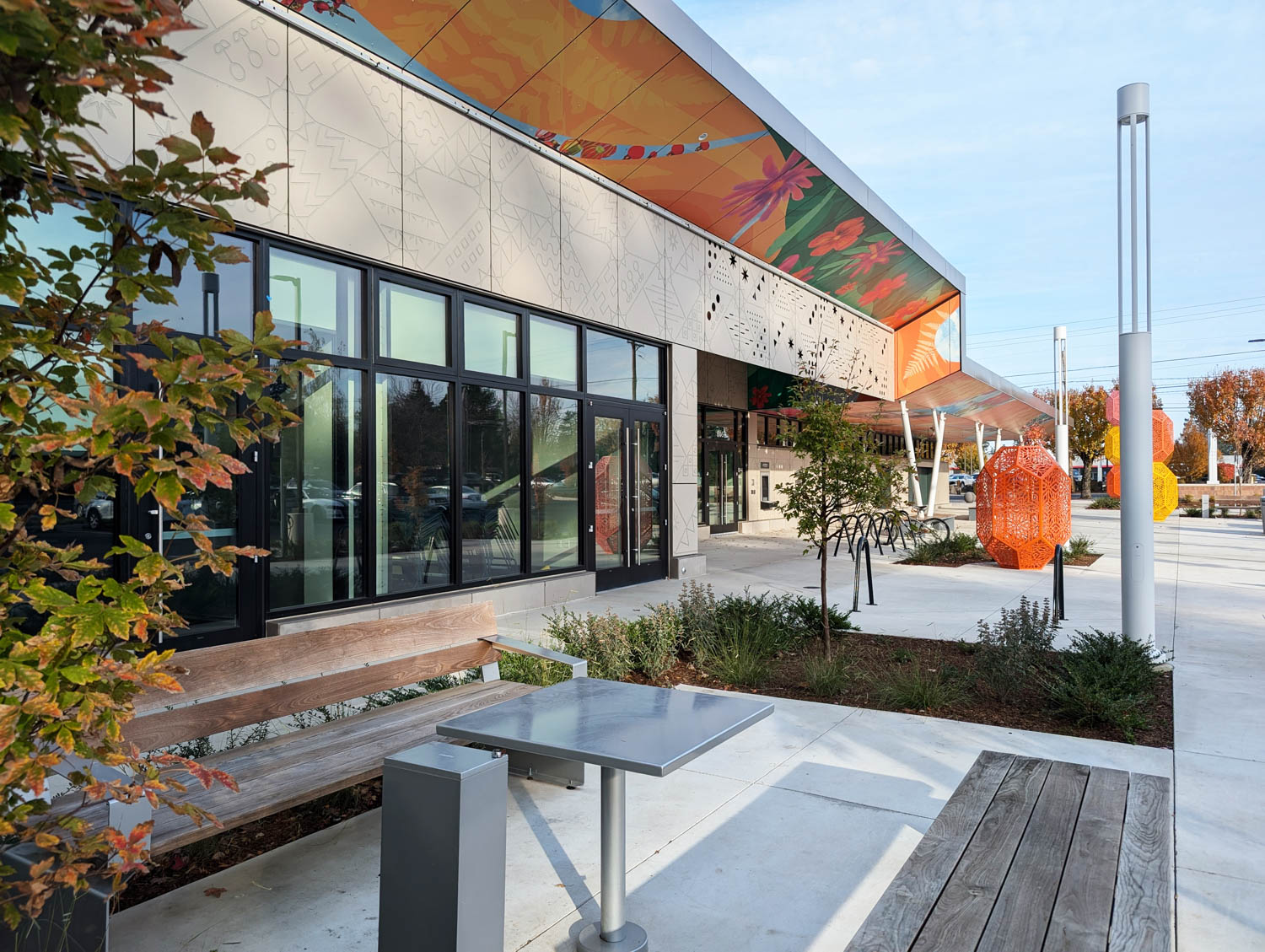 exterior of library with bright awnings and sculptures