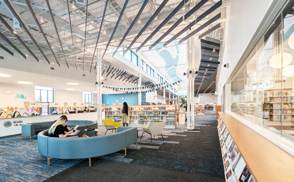 interior of library with curved blue chairs and bright lights