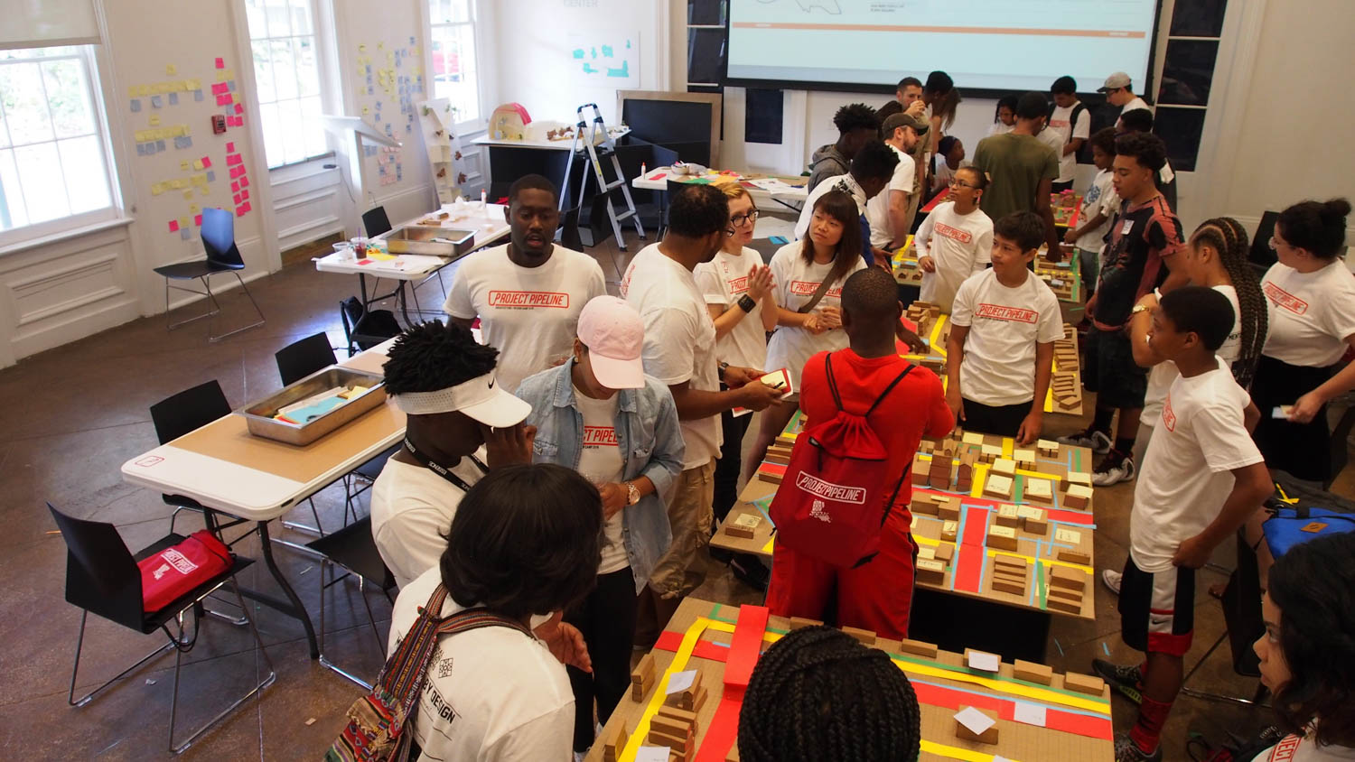 multiple students surrounding tables with blocks