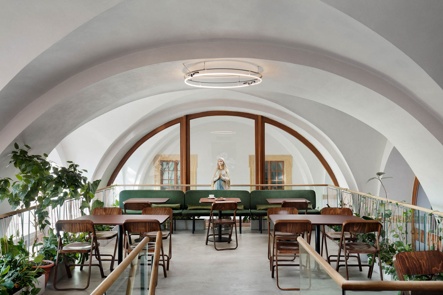 interior of cafe with brown chairs and green altar with the virgin Mary