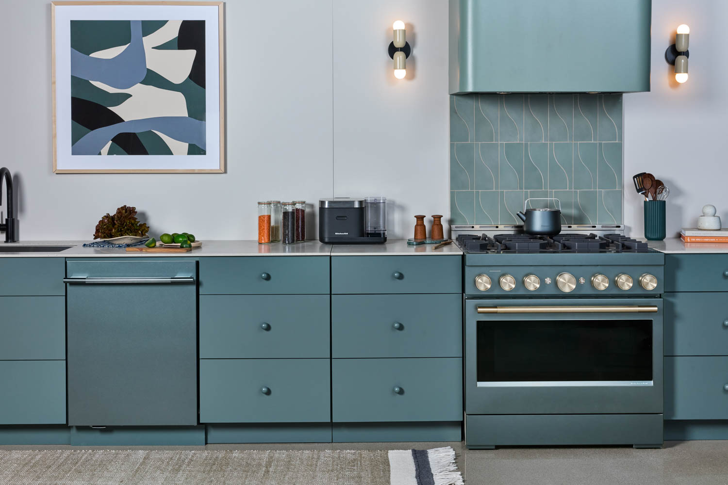 kitchen with light blue cabinets, dishwasher and stove and artwork