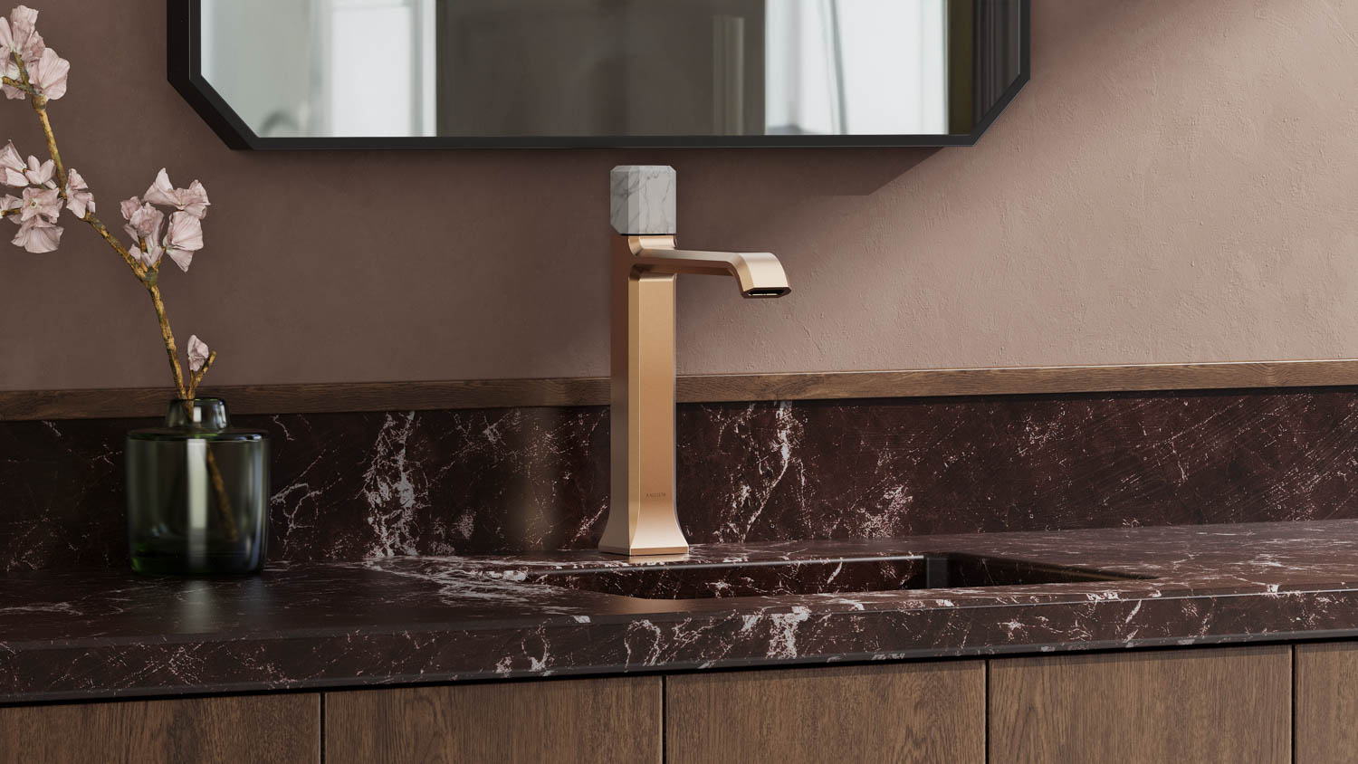 golden faucet on a black marble countertop with flowers