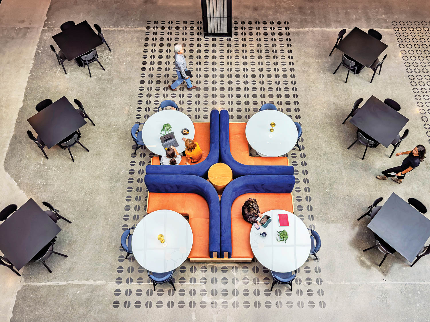 aerial view of atrium looking down at seating area with orange and blue booths