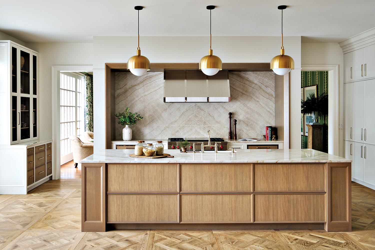 contemporary kitchen with a light oak island with white marble countertops