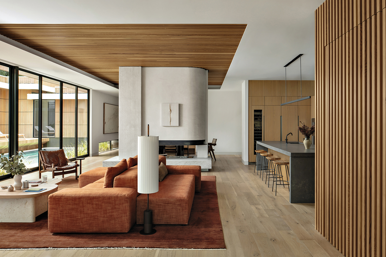 warm contemporary living room with an orange sofa and a reeded ceiling