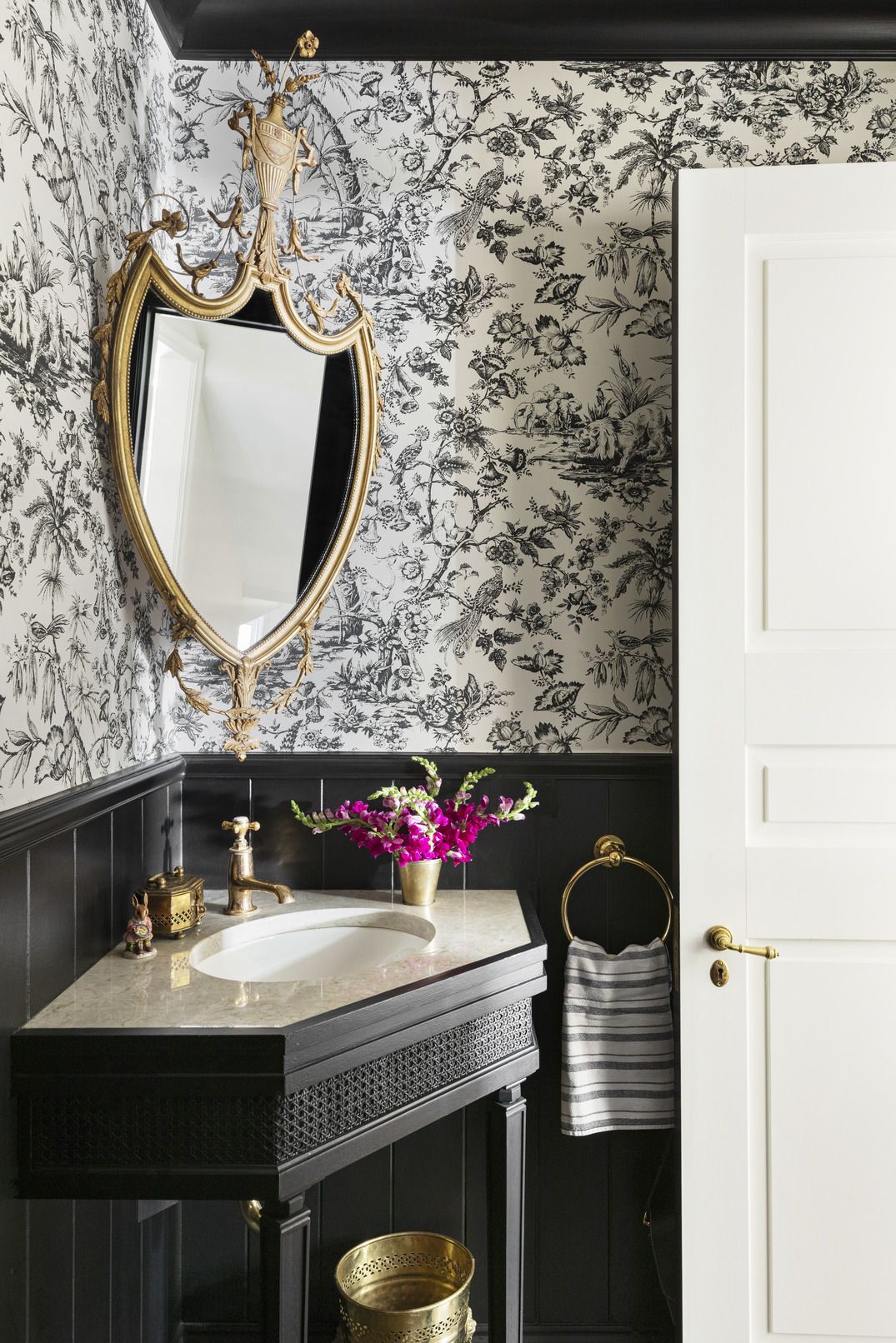 powder room designed by designer alexandra kaehler black and white wallpaper by pierre frey and beadboard painted in black by benjamin moore