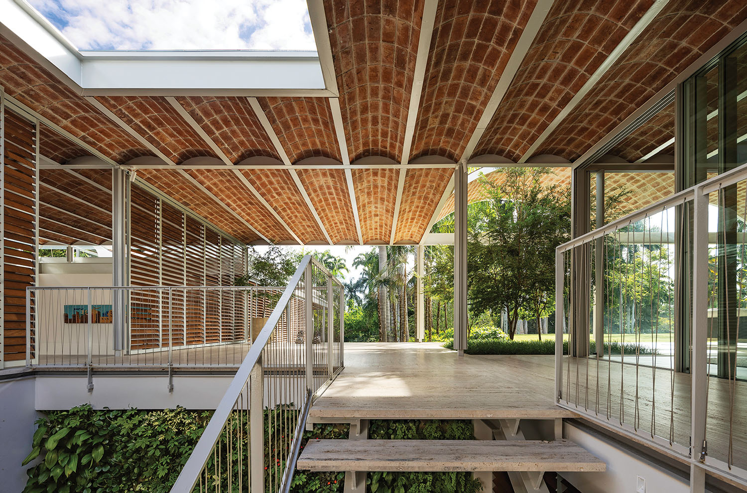 A porch with a wooden bench and a brick wall