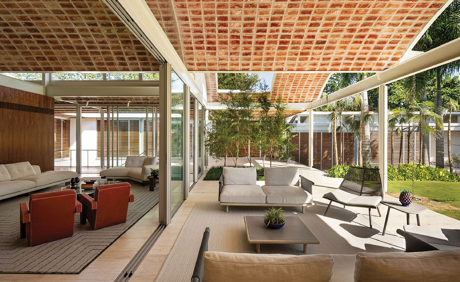 A covered patio with a couch and a table