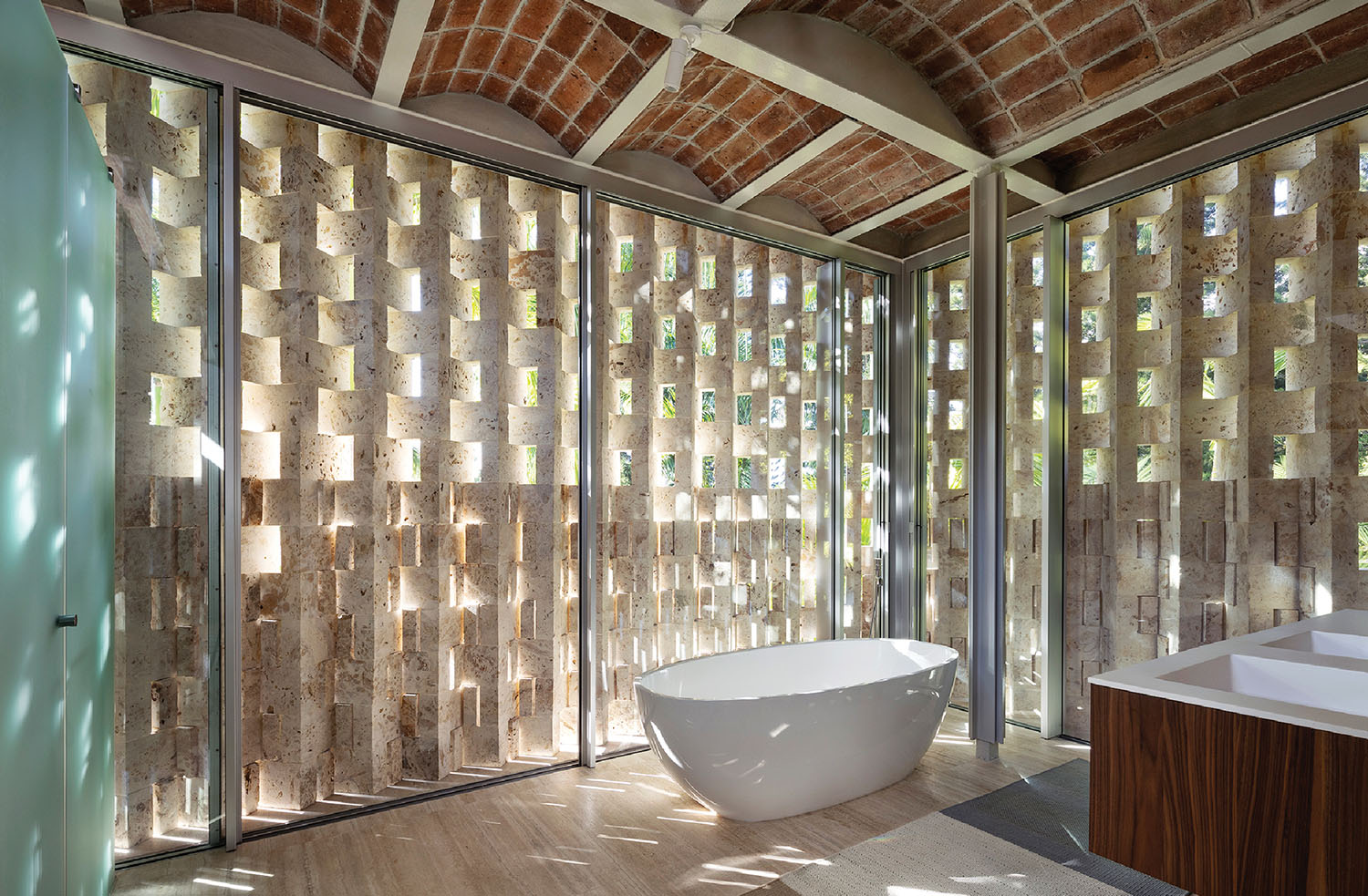 A bathroom with a tub and a large window