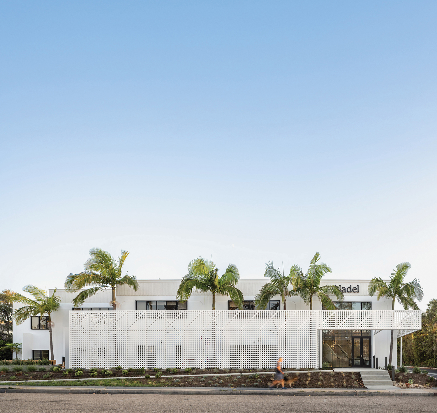 a white building with a white fence around it