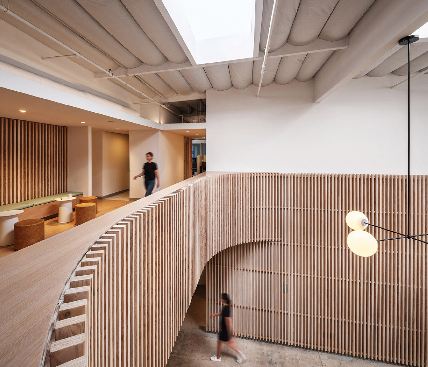 a wooden staircase leads to the second floor of the new building