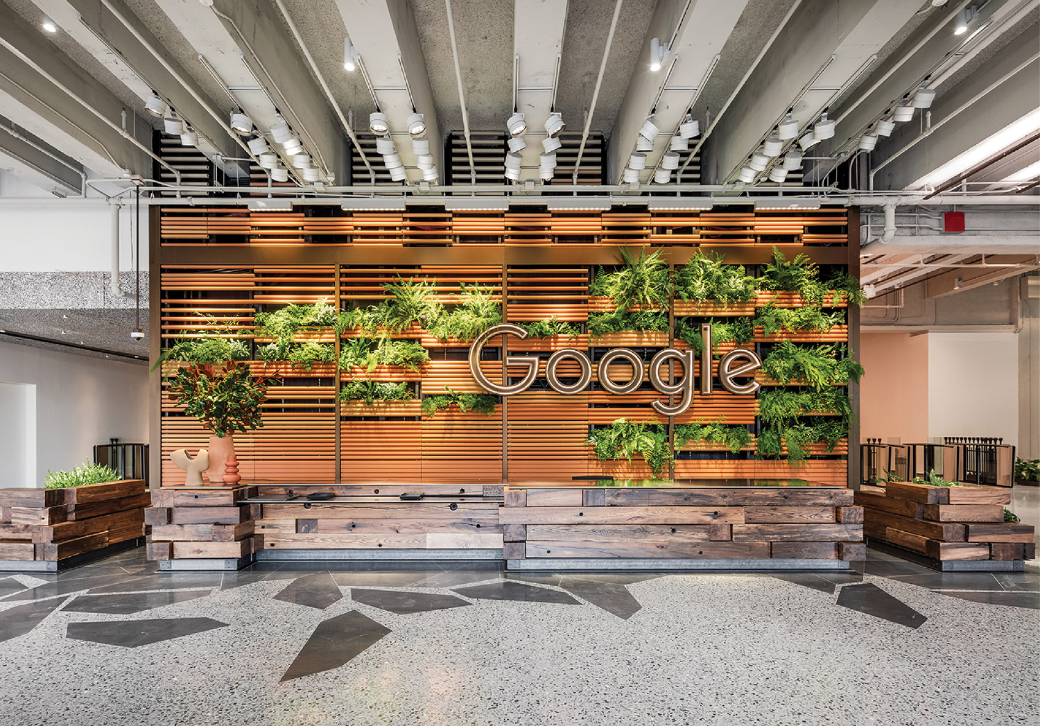 A large lobby with a large plant wall