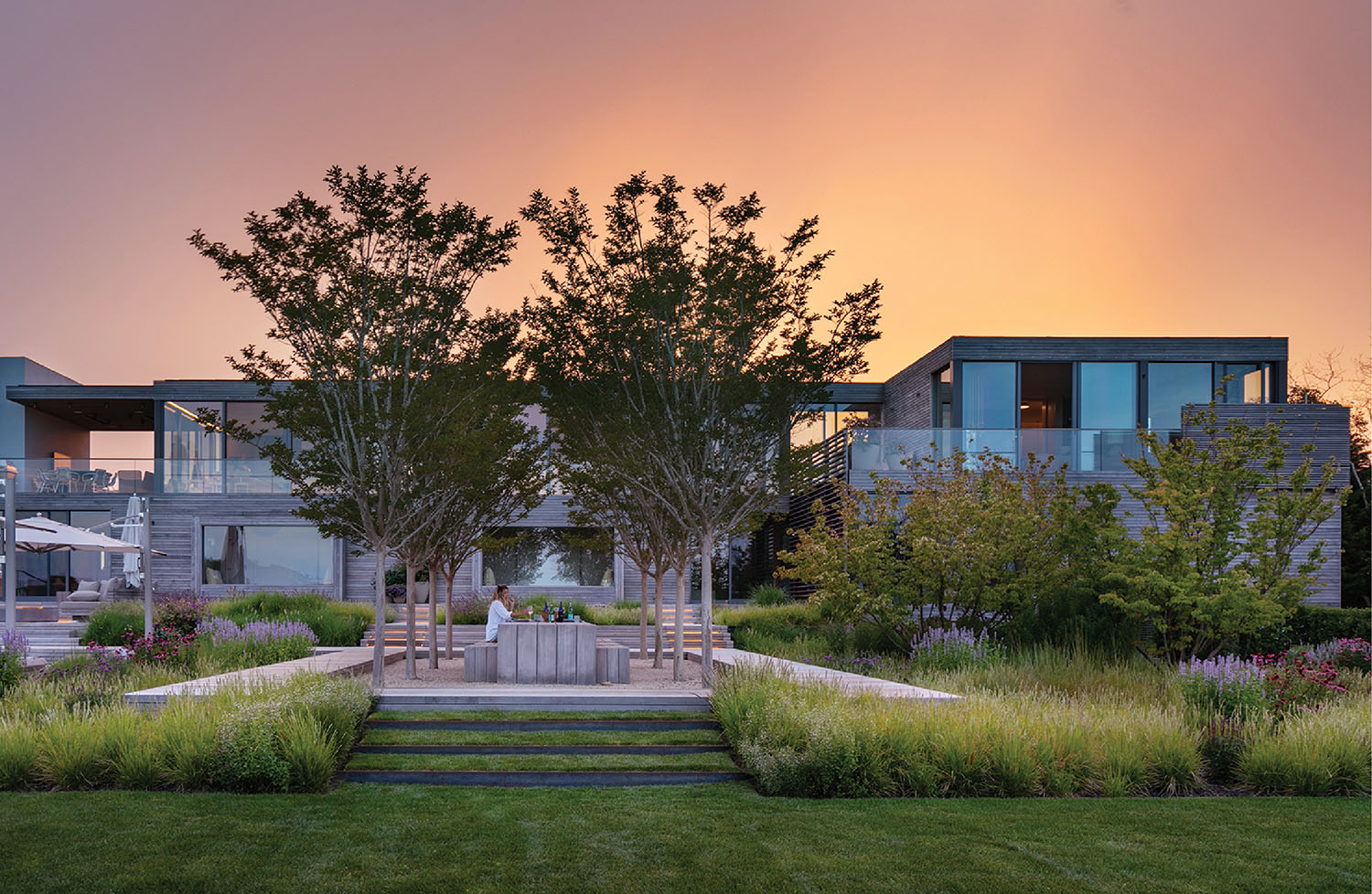 A modern home with a garden and a large lawn