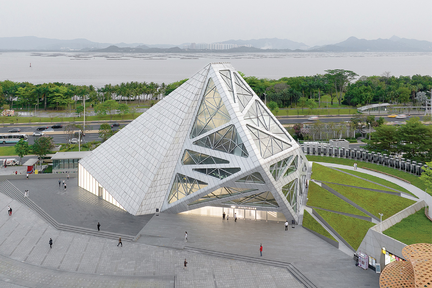 A large white building with a triangular shaped roof