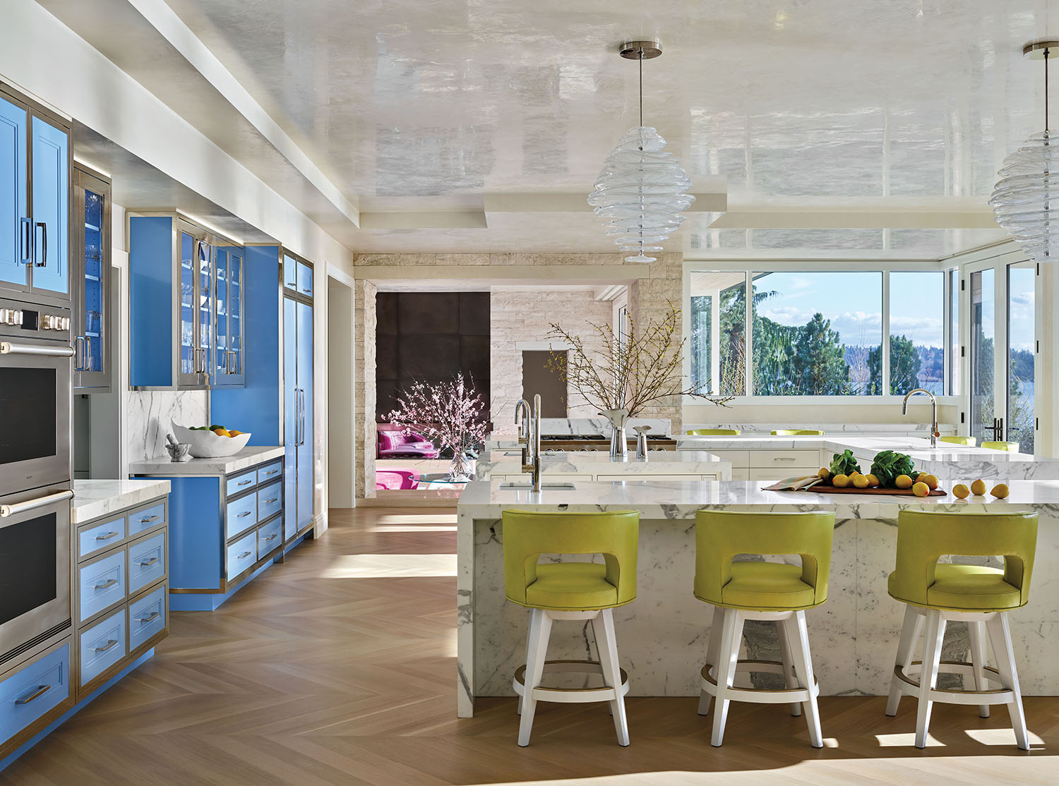 white modern kitchen with powder blue cabinetry and appliances and lime stools