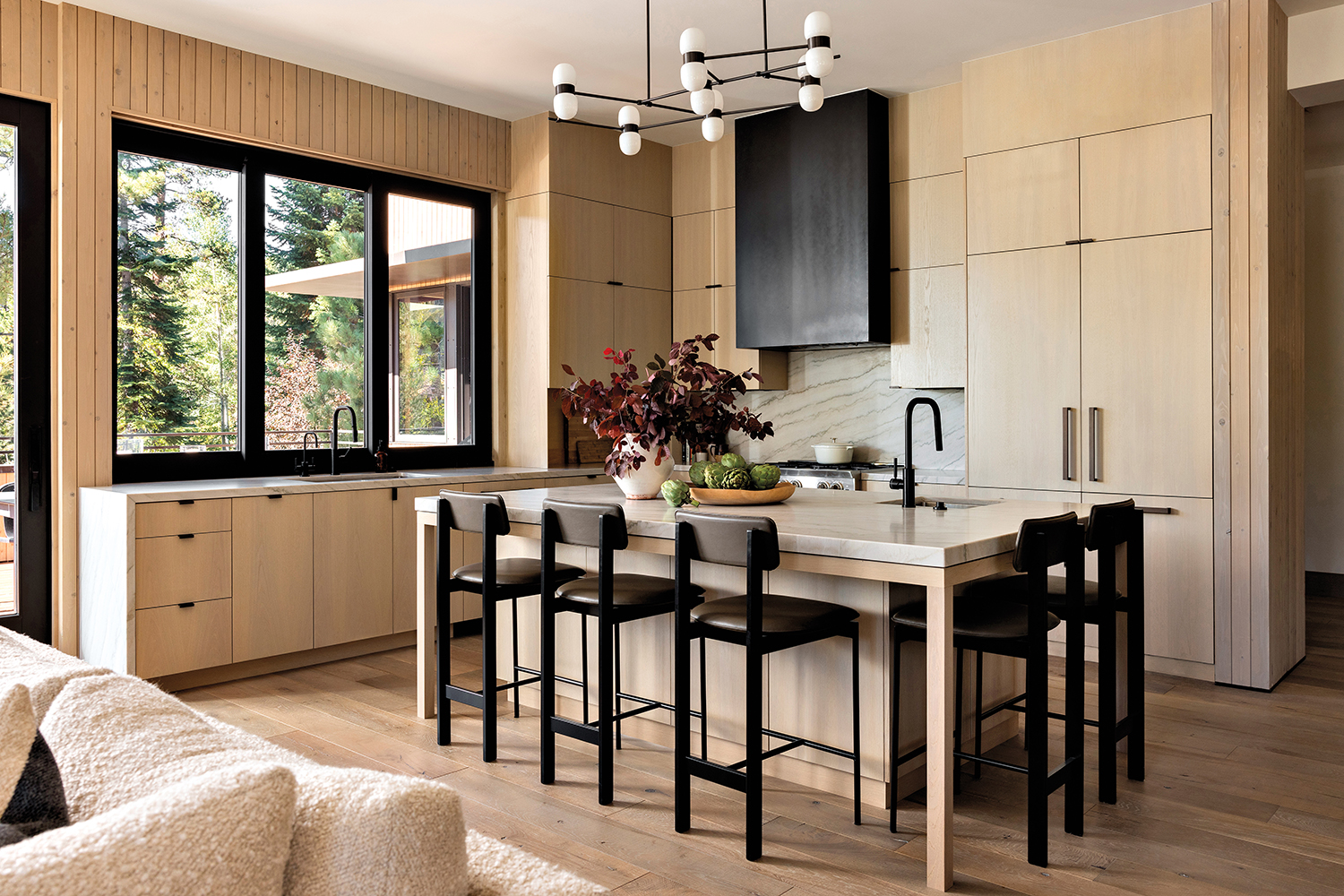 minimalist kitchen with white oak cabinetry and dark finishes 