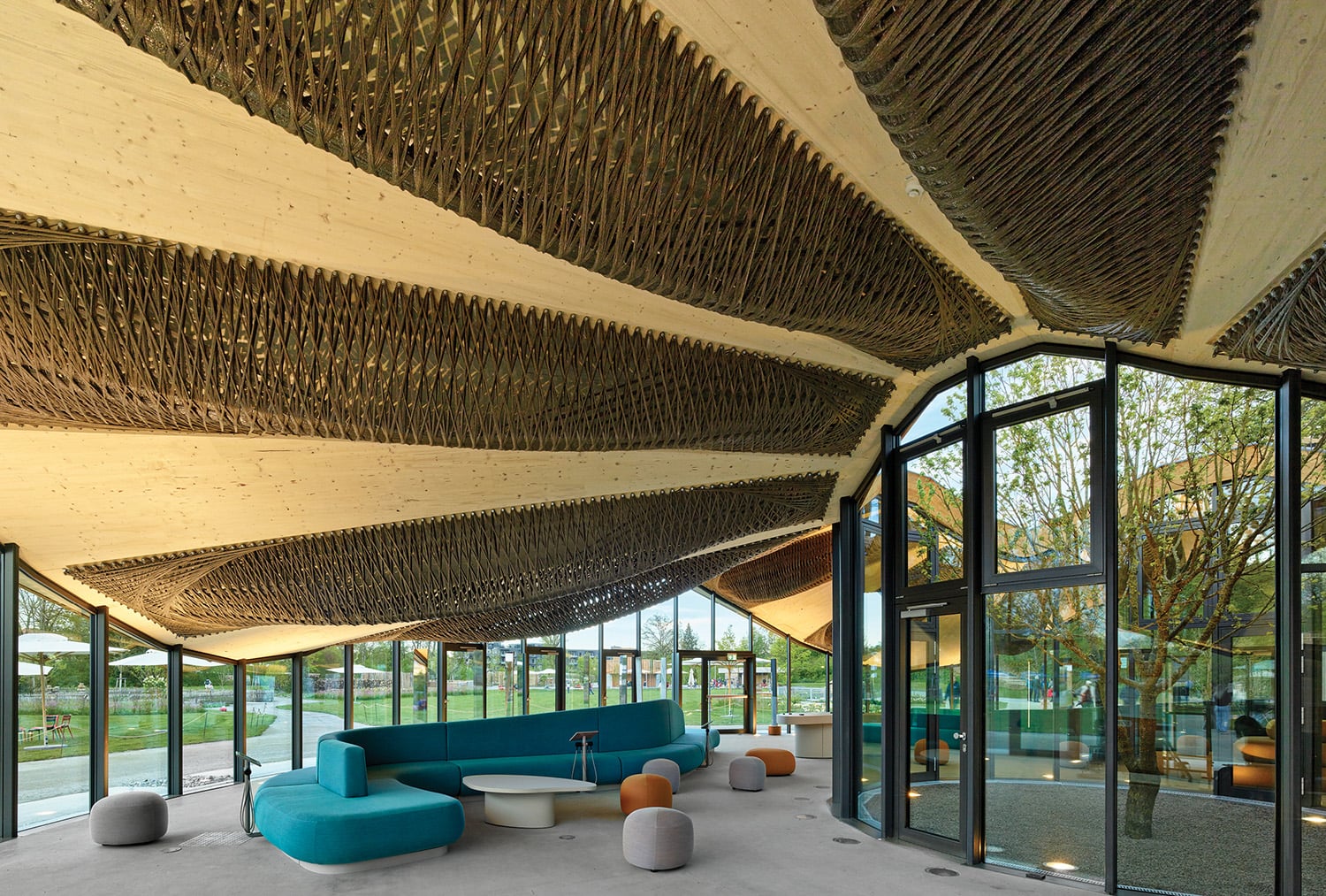 A room with a couch and a large wooden ceiling