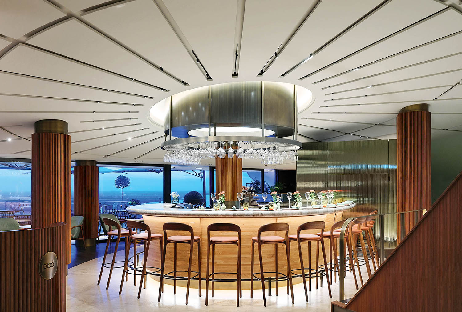 A modern kitchen with a bar and a large window