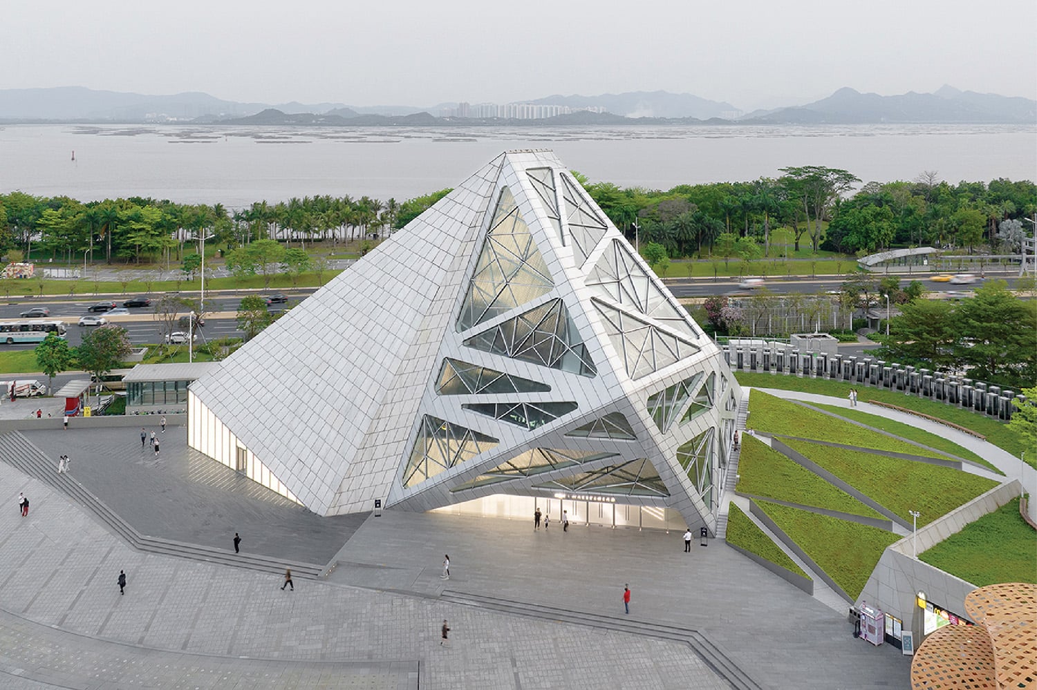 A large white building with a triangular shaped roof
